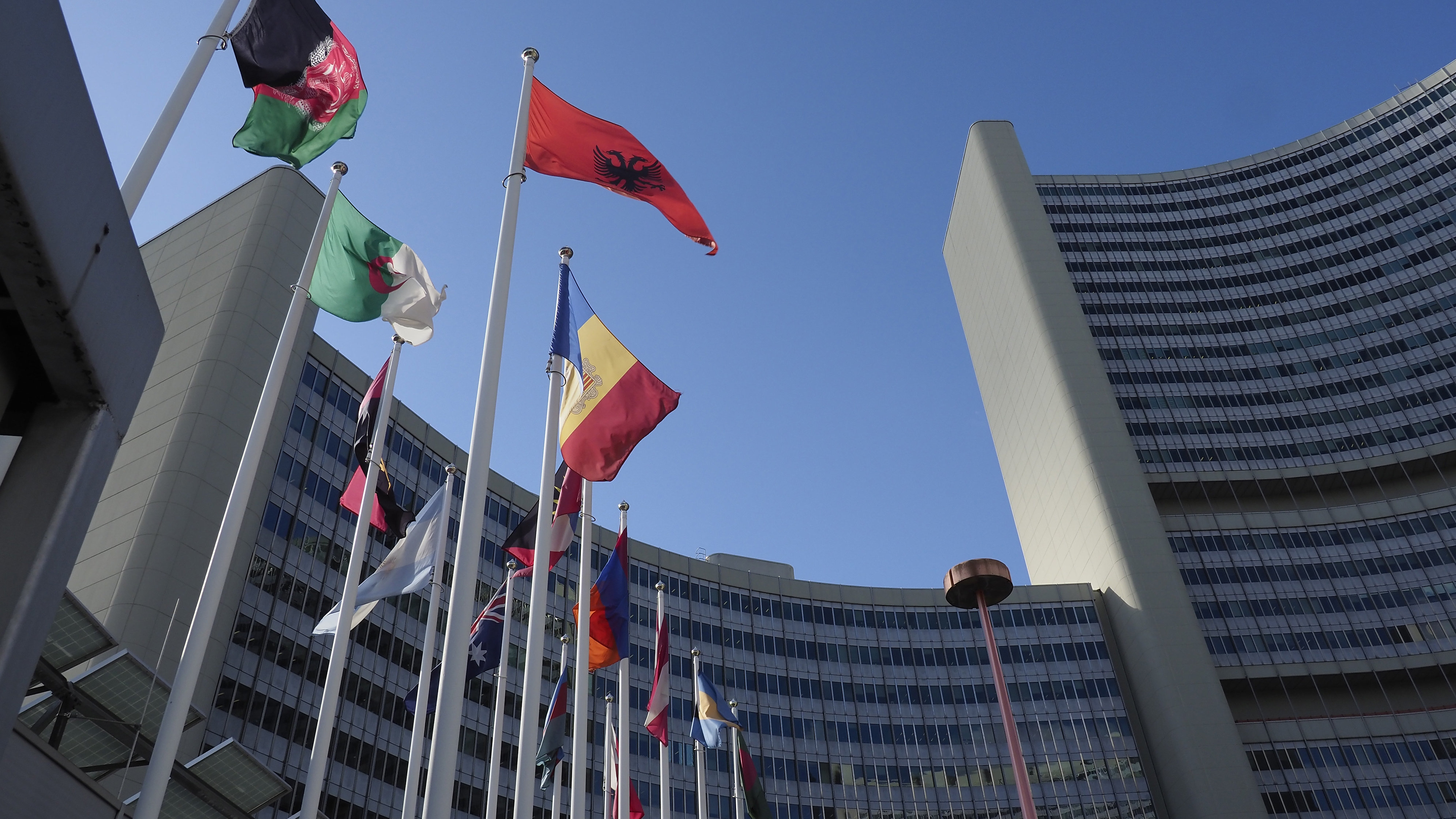 Building of the UN in Vienna with different flags in front of it